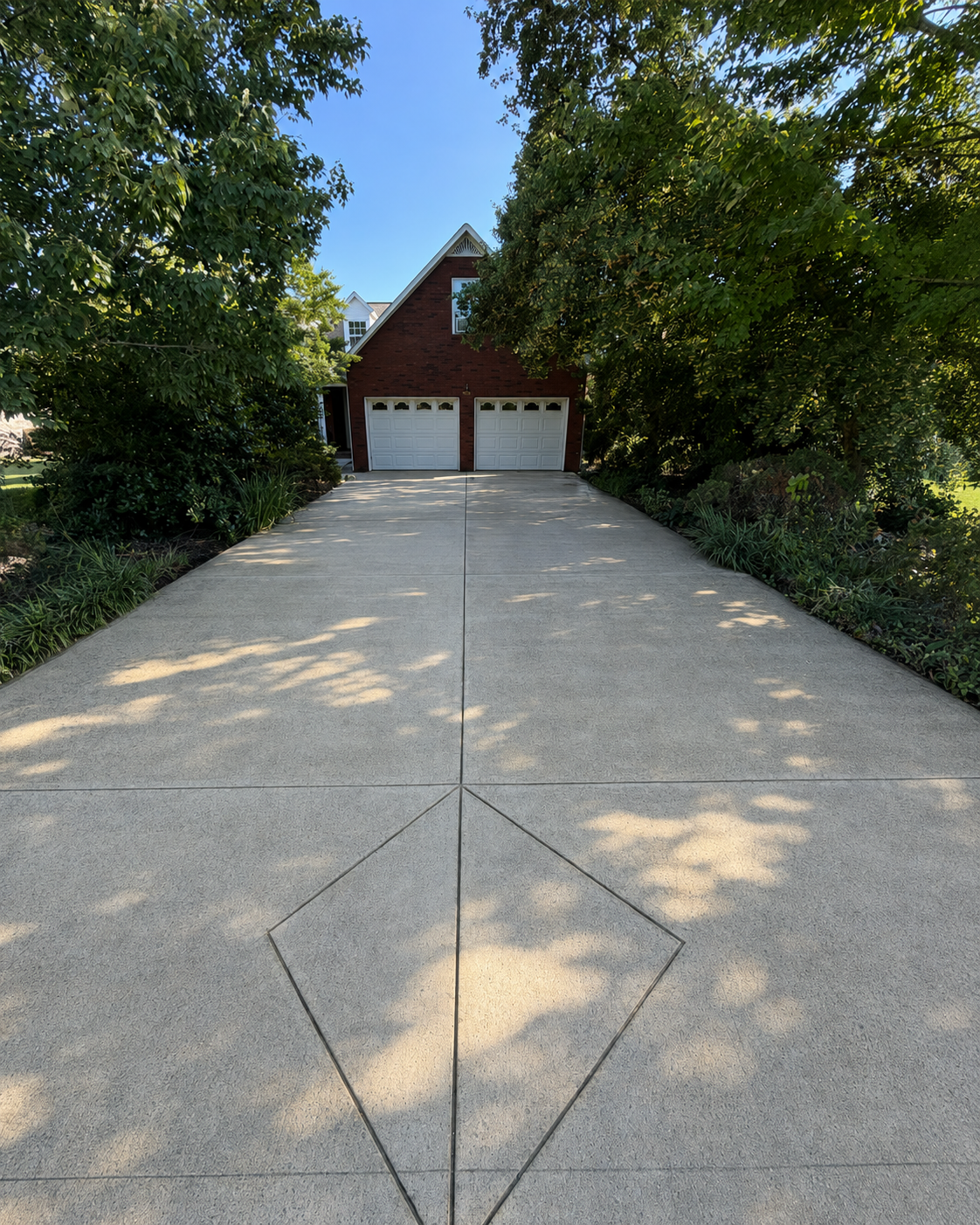 Freshly cleaned residential driveway after pressure washing near Cookeville Tennessee