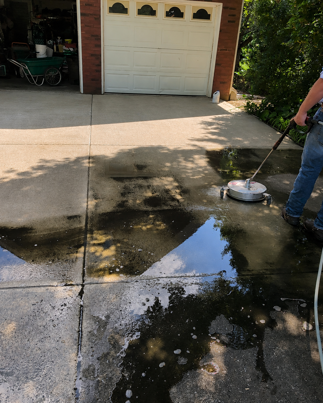 D and T Pressure Washing surface cleaning a residential driveway